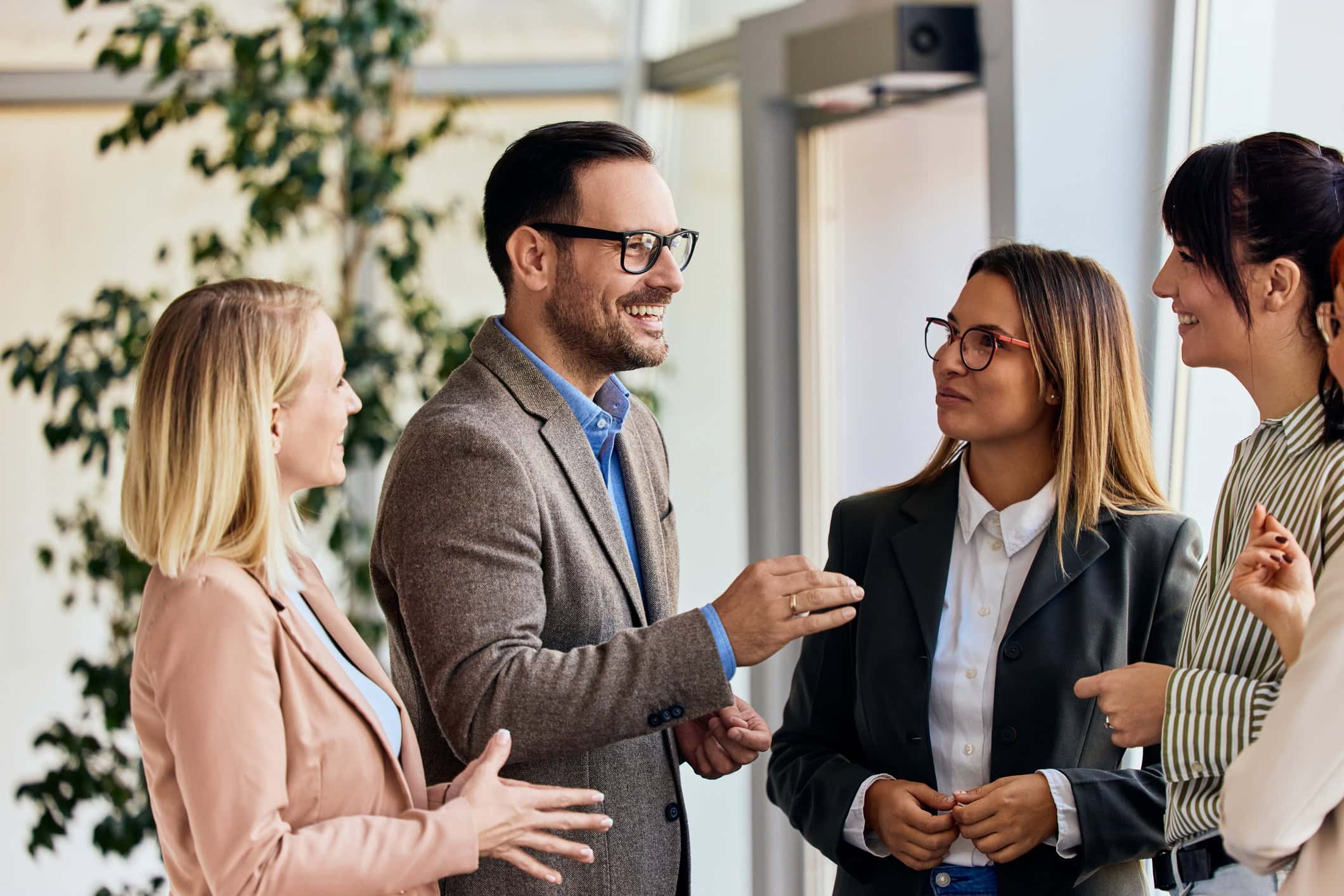 Business Professionals Engaging in a Productive Discussion in a Modern Office Setting Group of professionals exchanging ideas in a collaborative office environment.